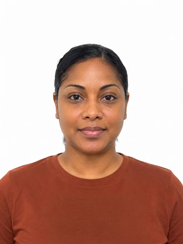 Example of a good photo: a woman facing the camera against a plain white wall, framed from mid-chest up with space above her head